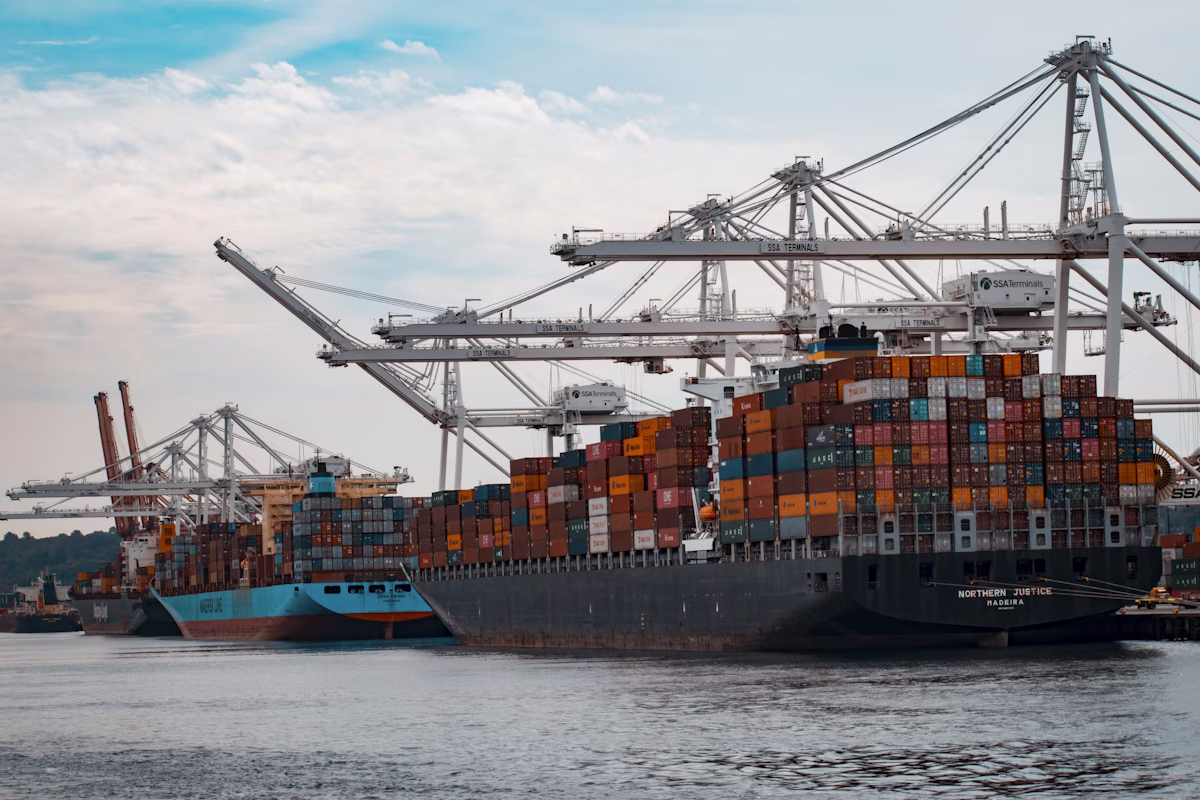 Port gantry cranes loading oversized cargo onto a vessel